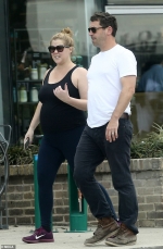 Amy Schumer shows off her blossoming bump during stroll with husband Chris Fischer in New Orleans
