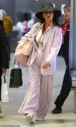 Catherine Zeta-Jones nails airport chic in a lilac suit and fedora hat as she arrives in New York