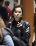 Emilia Clarke cuts a casual figure in a leather jacket as she touches down