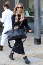 Caroline Flack steps out in a stylish black jumper and midi skirt