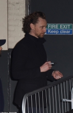 Tom Hiddleston looks in high spirits as he poses for selfies with fans