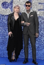 Kelly Osbourne stuns in low-cut black number and biker jacket while joined