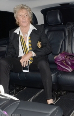Rod Stewart, 74, lives up to his rocker status as he sports an undone tie while making a VERY
