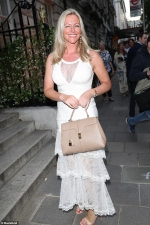 Michelle Mone puts on a busty display in a cream gown with racy lace panels