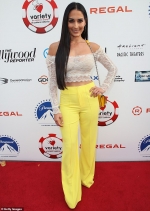 Nikki Bella flaunts her cleavage and midriff in cropped lace top and yellow