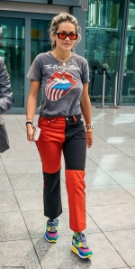 Rita Ora cuts a casual ensemble in a Rolling Stones T-shirt and split colour