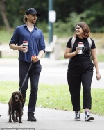 Tom Hiddleston steps out with female friend as he takes his dog for a stroll