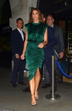 Cindy Crawford, 53, looks incredible in green satin midi dress as she leaves