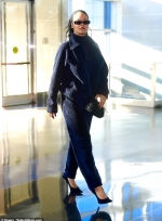 Rihanna is the ultimate jet-setter as she pairs fleece tracksuit with stilettos