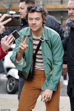 Harry Styles rocks another black leather Gucci bag as he greets fans following BBC R2 appearance...