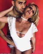 Britney Spears flaunts cleavage as she cuddles up next to beau Sam Asghari