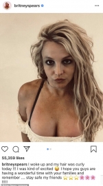 Britney Spears puts on a busty display as she shows off wild curly hair