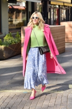 Ashley Roberts looks chic as she colour clashes in bright pink coat