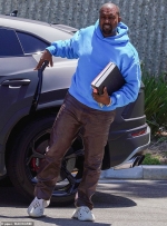 Kanye West dons his new Yeezy Foam Runners and a bright blue hoodie