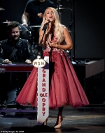 Carrie Underwood stuns in a thigh-skimming gold dress as she performs