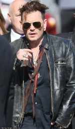 Johnny Depp puffs away on a cigarillo as he arrives for interview