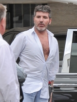 Simon Cowell's heavily exposed chest puts a smile on girlfriend