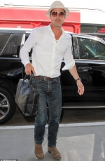 Brad Pitt looks cool as a cucumber as he jets out of LA despite blaze