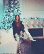 Khloe Kardashian works glamorous thigh-high boots as she celebrates