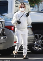 Pregnant Ashley Tisdale looks ultra cozy in an ivory hoodie and sweatpants while taking