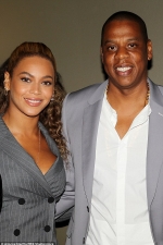 Beyonce shows some cleavage in plunging suit as she joins husband Jay Z for pal Usher's