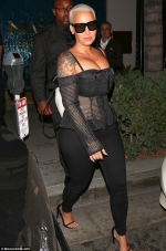 Amber Rose puts on a busty display in a racy corset top she heads