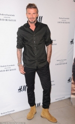 David Beckham looks dapper in a black dress shirt with the sleeves rolled