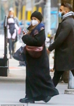 Ashley Olsen bundles up in full-length black overcoat and knit beanie as she