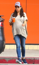 Pregnant Mila Kunis goes casual cool as she covers her bump in baggy