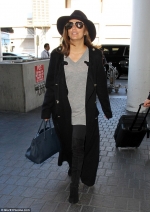 Eva Longoria wraps up snug for flight out of LA...after denying