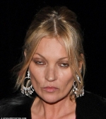 Bleary-eyed Kate Moss puffs on suspicious-looking cigarette in private jet's cockpit...