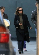 Victoria Beckham cuts a low profile in shades and a black