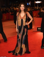 Eclectic Maggie Gyllenhaal is typically striking in a low cut gold and black floral