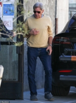 Harrison Ford cuts a casual figure as he wears a yellow crewneck sweater
