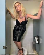 Katy Perry works a leather skirt and plunging top as she strikes a pose on a TOILET SEAT