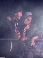 Victoria Beckham cosies up to bleary-eyed husband David at Glastonbury as the couple