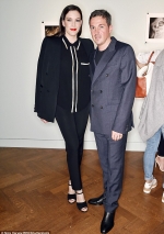Liv Tyler power dresses in a classic suit beside fiancé Dave Gardner...