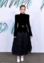 Rita Ora rocks a Gothic look as she dons intricate hair piece and highlights her tiny waist