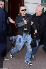 Johnny Depp puffs on a cigarette as he steps out in Poland after worrying