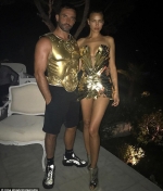 Irina Shayk flaunts cleavage and long legs in gold metallic dress