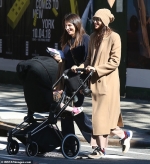 Shayk smiles as she steps out with daughter Lea for a stroll in NYC...