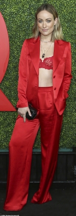 Olivia Wilde lives up to her name by flashing her lace bra through scarlet silk suit as she joins Charlotte