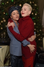 Rose McGowan looks festive in an all red ensemble as she poses with pal Jaime Winstone