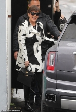 Kris Jenner sports chic black and white coat while dodging the rain in LA... as it's revealed youngest daughter