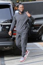 Kevin Hart flashes a smile and peace sign during family lunch with wife and kids...