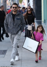 Scott Disick's daughter Penelope, six, waltzes out of Gucci store with gift bag while wearing