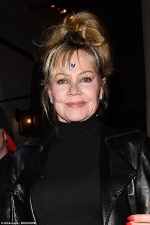 Melanie Griffith accessorises her look with quirky silver heart sticker