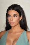 Kim Kardashian showcases curvaceous figure in clinging blue bodysuit as she plugs latest